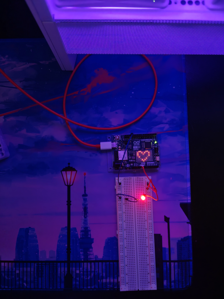 An Arduino Uno board displaying a heart.